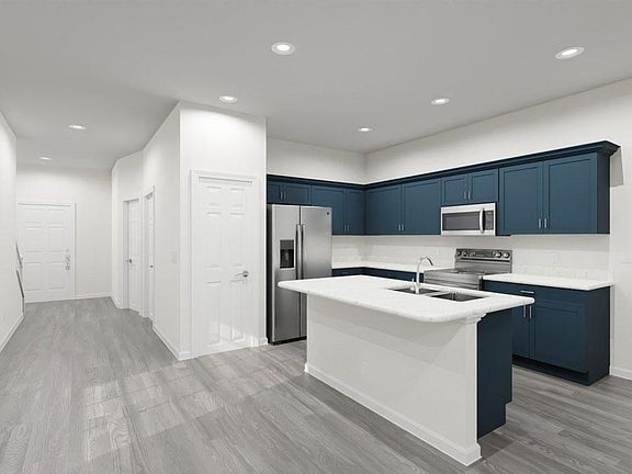Open kitchen with counter-height island with features and finishes hand-selected by our design profe