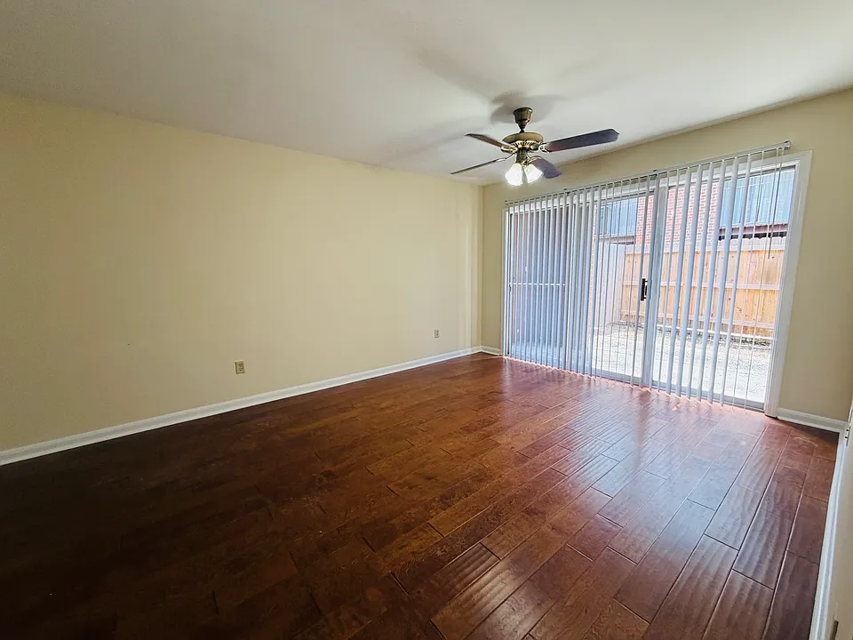 Living room with private fenced in patio
Wood floors 
New paint