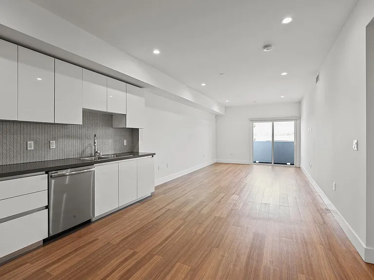 Open-Concept Kitchen, Dining, and Living Room Space with Patio