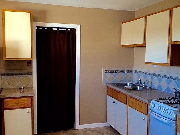 utility room beside kitchen