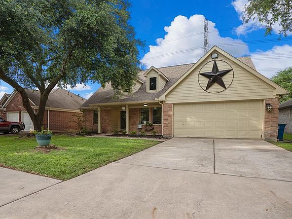 Check out that curb appeal! A lovely mature tree gives an abundance of shade & adds to the beautiful fresh landscaping along the porch of the home. Hardy board replaced the wood siding in 2019 & the neutral paint matches perfectly w/ the brick exteri