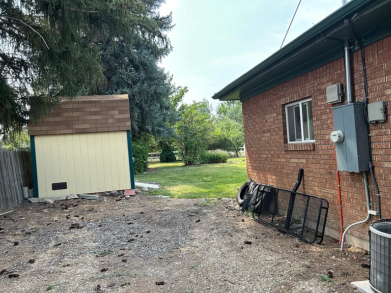 East side of house, shed and backyard