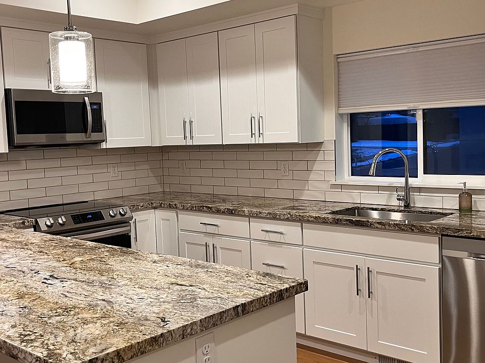 Granite with White Cabinets and Stainless Appliances.