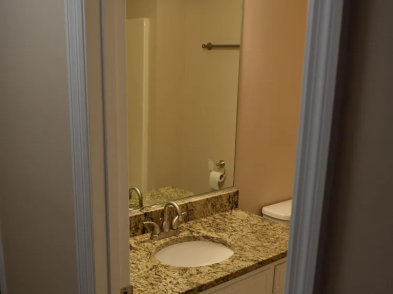 Walk out of bedroom 2, turn left & immediately on the left is the hall bath with granite vanity & shower/tub surround