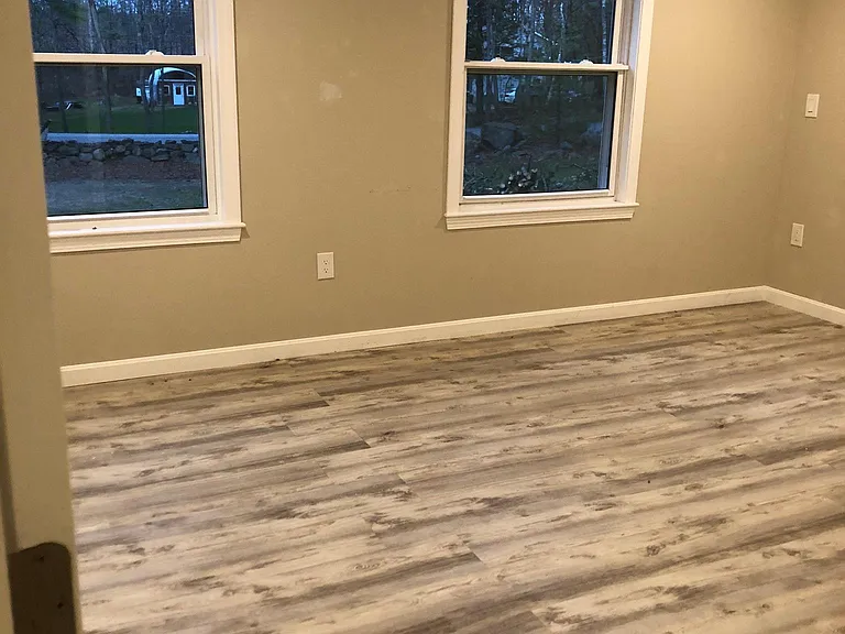 Main bedroom has mini-split for heating/cooling, a ceiling fan, and two large windows - plenty of room for a king-size bed