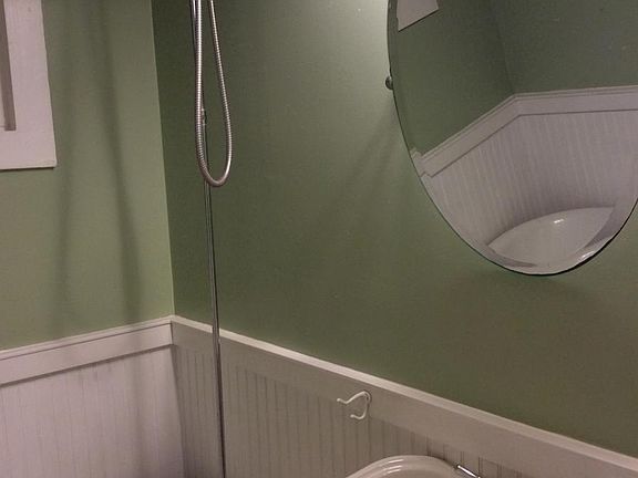 Deep soaking clawfoot tub with shower feature.