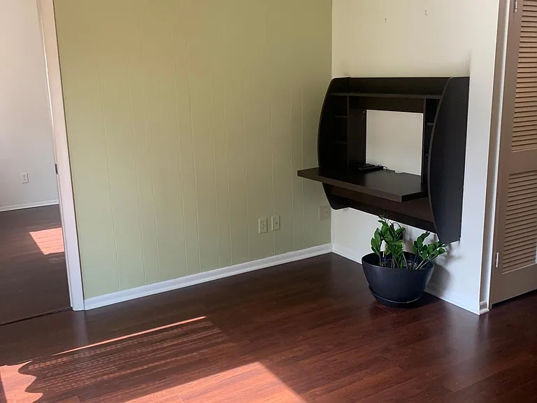 recessed area with desk in den adjoining kitchen