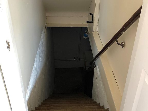 Unfinished basement off of the kitchen