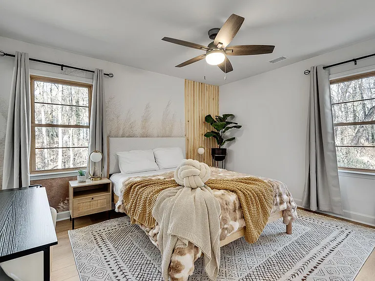The styled bedroom with two windows: Two windows, one view: wake up to the creek every morning.