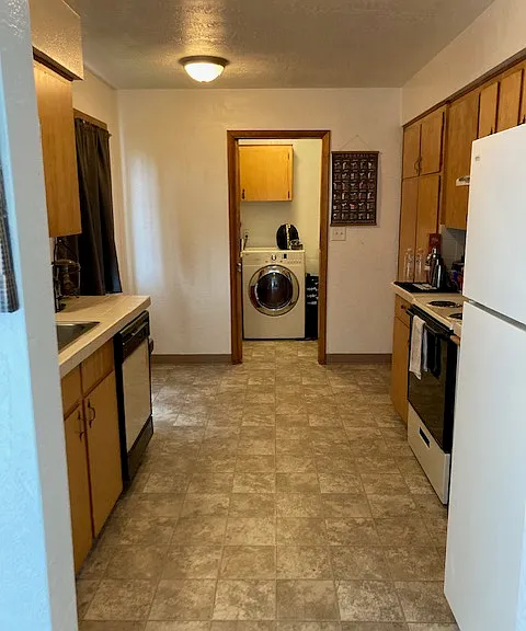 Kitchen leading into separate laundry room