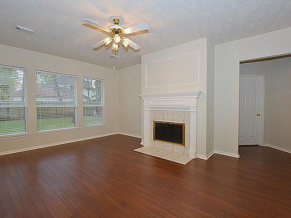Living room with the master bedroom entrance past the fireplace on the right