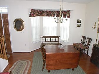 Dining room with bay window and wood floors
