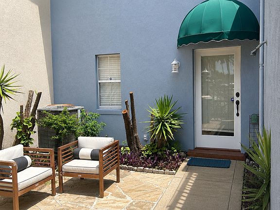 Private front courtyard is a cozy transition from beach to your front door and an inviting welcome for guests.