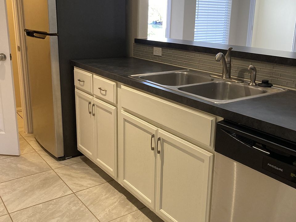 Kitchen with bar behind sink