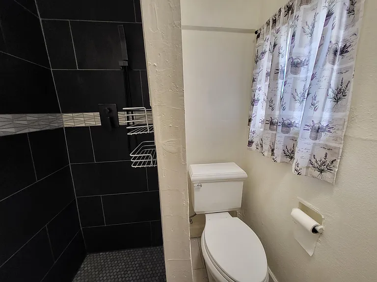 Second bathroom separated toilet area.