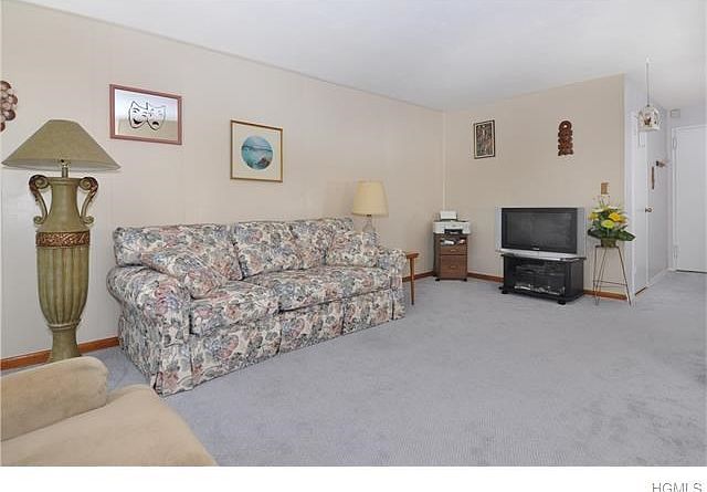 Another view of the living room and front door area