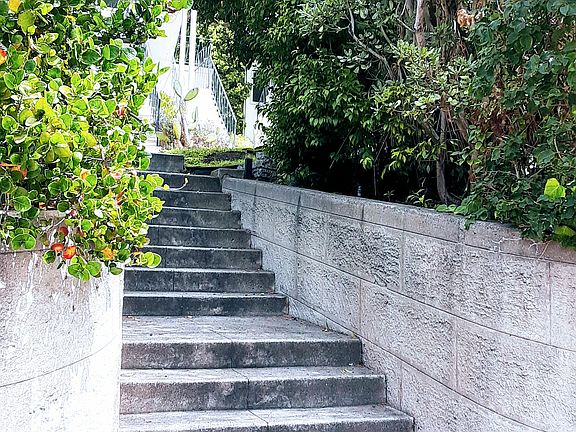 Rustic stone steps set the building off from the street