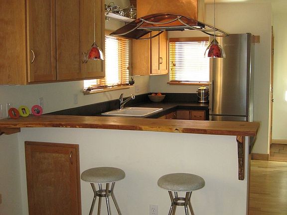 Bright and open eating area with maple ‘live edge’ countertop bar