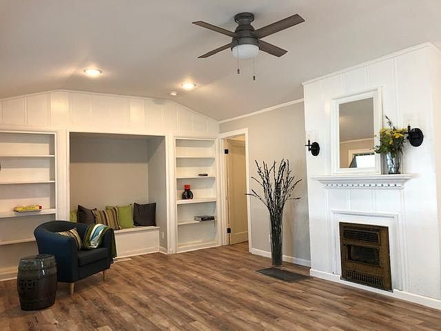 Walk into this spacious living space with original details: built in bookshelves, bench seat, fire place. New wood laminate floors, new lighting, ceiling fan, large picture dual pane windows.