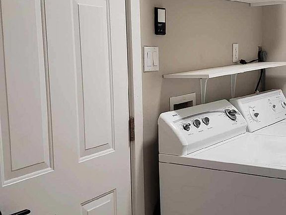 Laundry room includes washer and dryer. Has cabinets, plus storage closet.