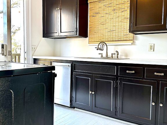 Kitchen with newly painted cabinets and floor