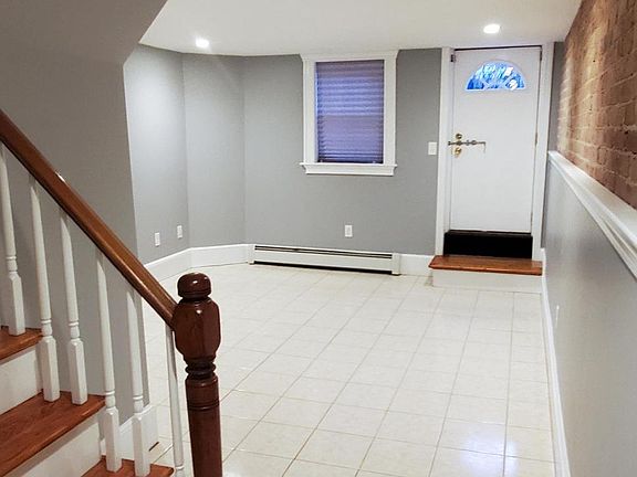 Expansive lower level, with bedroom, bathroom, laundry room, & back entrance to private patio