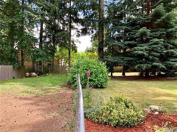 The lot to the left of the chain-linked fence is part of the property.