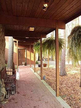 Covered entry with paver walkway and "desert driftwood" stone front.