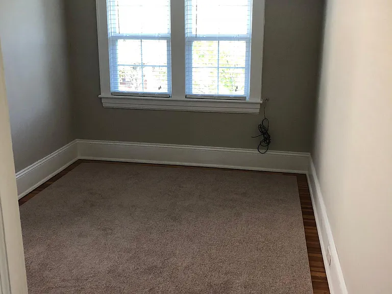 Entrance to second bedroom with three windows and roomy clos