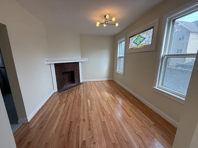 Beautiful dining room with original fireplace and stained glass window.