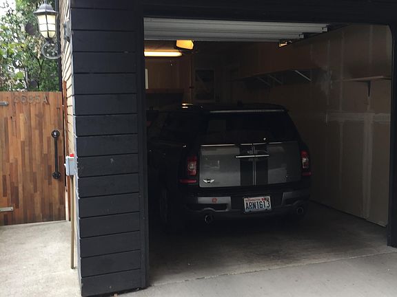 One car garage with storage space. Main entrance through gate at left.