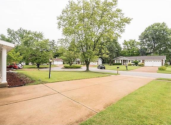 This is the view from the Garage Area to the quiet cul-de-sac of homes.  Notice the planting parkway accent within the street court.
