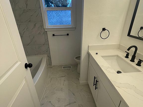 Remodeled bathroom. New tub, fixtures, tile flooring, cabinets with quartz countertops.
