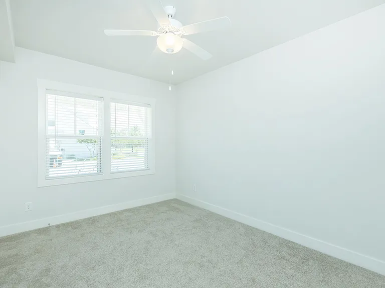 2" FAUX WOOD BLINDS AND CEILING FAN IN BEDROOM
