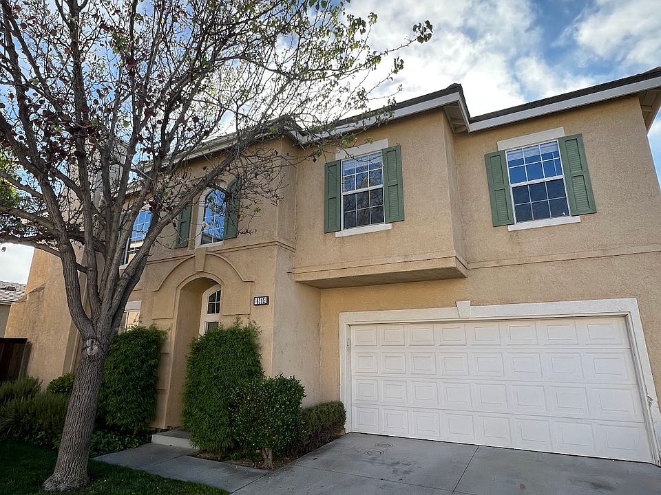 Front view of freestanding 4 bedroom home with 2.5 baths, and a 2 Car Garage.