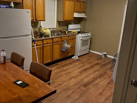 Living room connected to the kiytchen and divided by island table for sitting and eating. Kitchen has brand new hard wood limerent flooring. Including Refrigerator and Stove with range (electric).