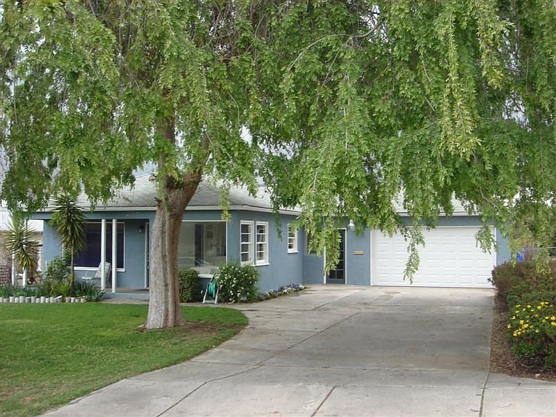 Nestled behind a lovely shade tree