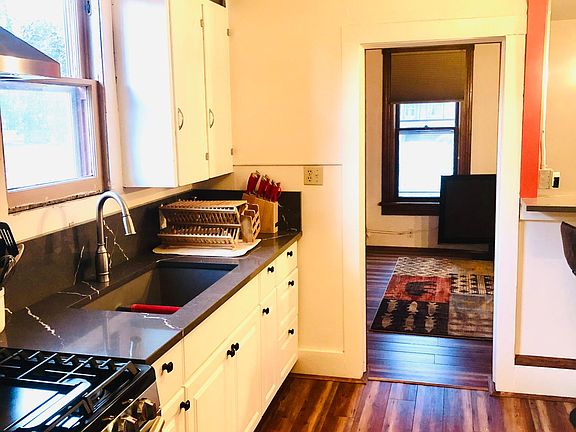 Quartz countertops, gas range, and stove, looking into the living room