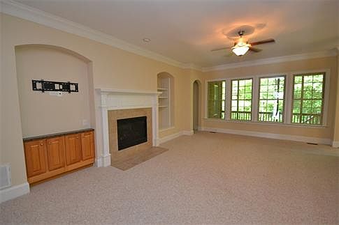 Great Room: Gas fireplace is framed by built-in bookcase to the right and connections for wall-mounted tv to the left
