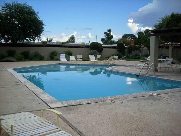 Community pool area has hot tub, grills, clubhouse with kitchenette and pool table, and restrooms. Tennis court also on site.