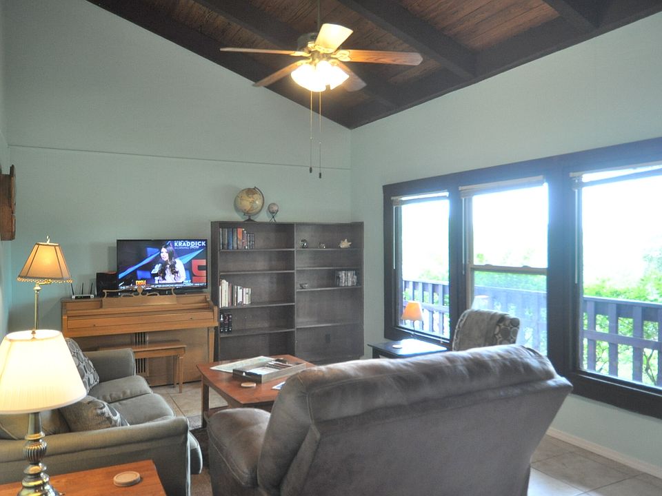 Vaulted wood ceilings and wall of windows in living room