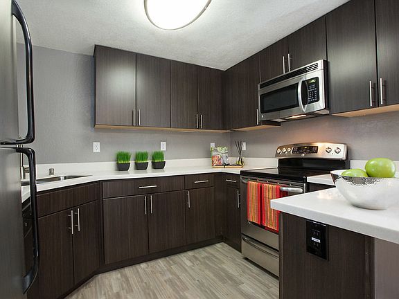 Staged kitchen with quartz countertops, stainless steel appliances, and hardwood style flooring.