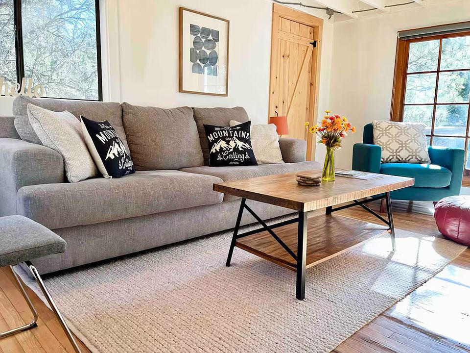 Living room with closet and windows on three sides