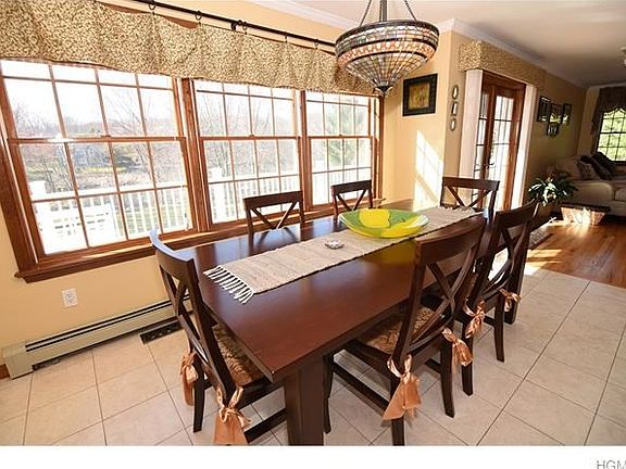 Over sized dining area overlooks private yard and expansive custom decking.
