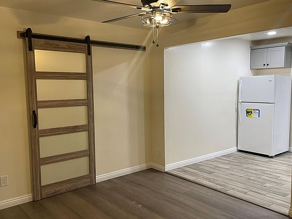 View of barn door facing the living room and portion of the kitchen.