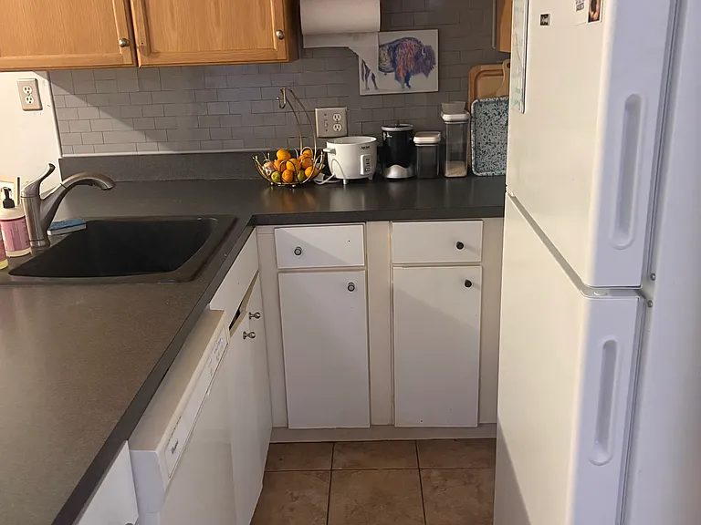 Attractive, durable tile floor in kitchen. Ample storage.