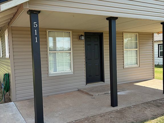 Covered porch, new siding, freshly painted door and posts.