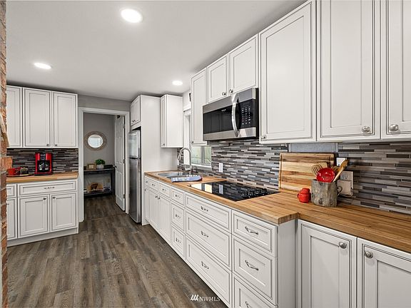Kitchen boasts butcher block countertops,