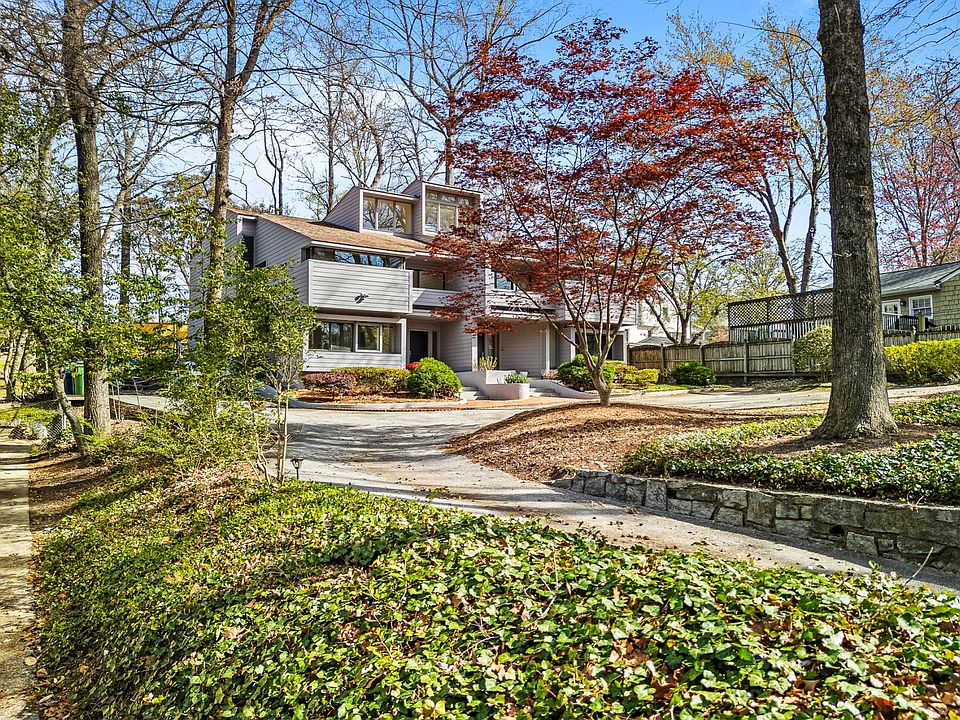 Mid-century modern hilltop home in Buckhead with a private driveway and two dedicated parking spaces right next to the townhome
