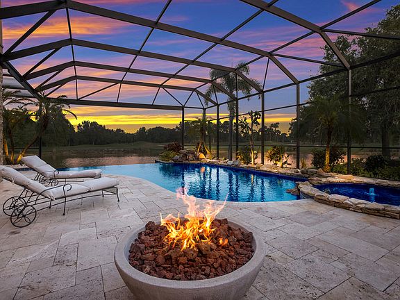 Outdoor area with gas fire pit and infinity-edge pool